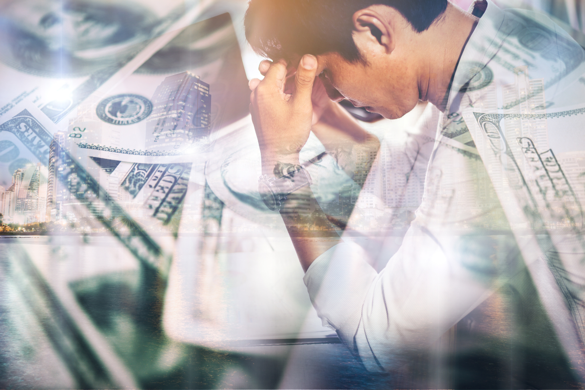 Conceptual illustration representing ID Software with a stressed individual, layered U.S. currency, and cityscape imagery symbolizing financial strain, business disruption, economic uncertainty, and software industry challenges.